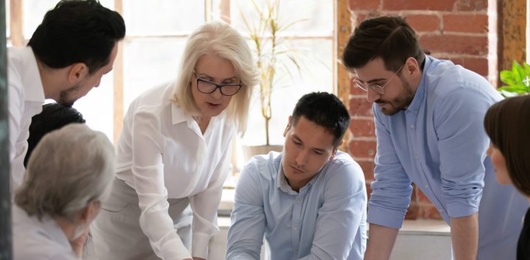 Team of people looking down at something on a table