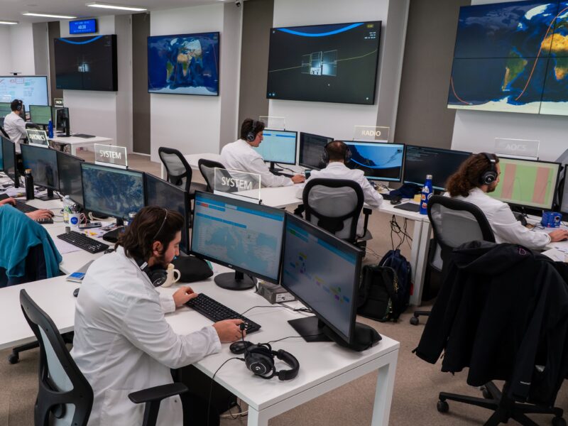 People sitting at desks working on screens as part of space ground segment activity at Argotec
