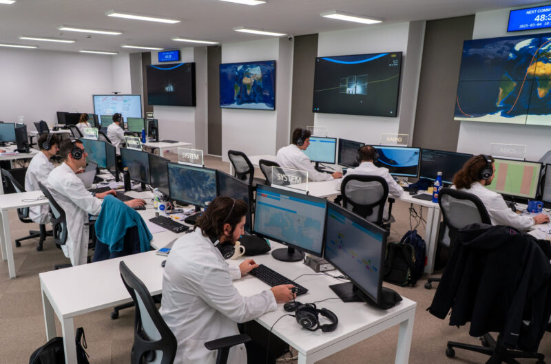 People sitting at desks working on screens as part of space ground segment activity at Argotec