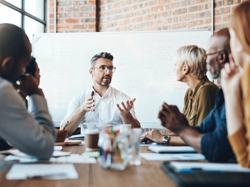 Male team leader talking to group