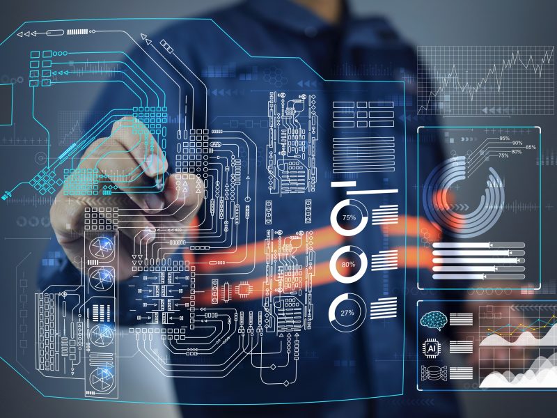 Person drawing engineering diagram on transparent screen