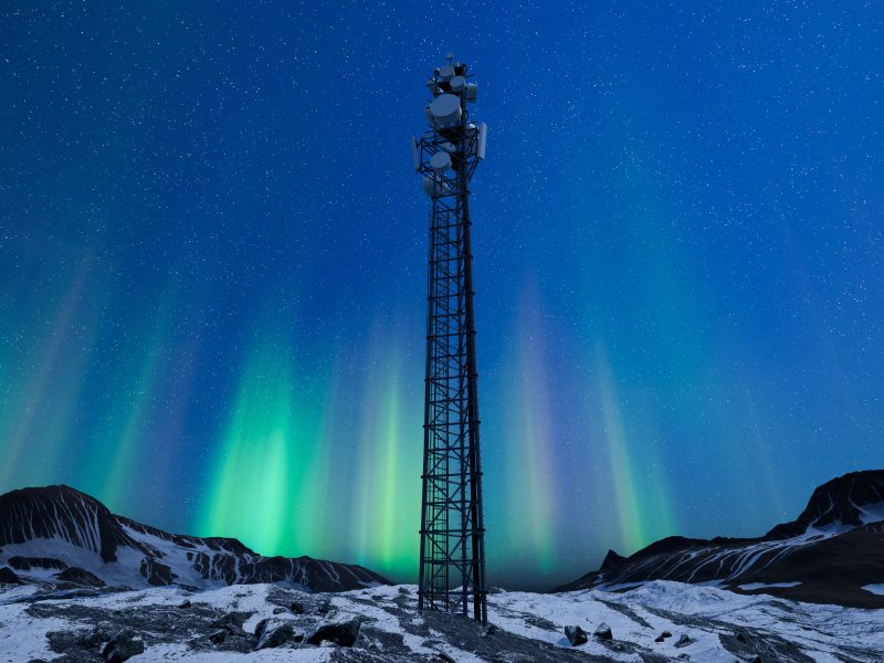 Radio mast seen against a dark sky with visible northern lights