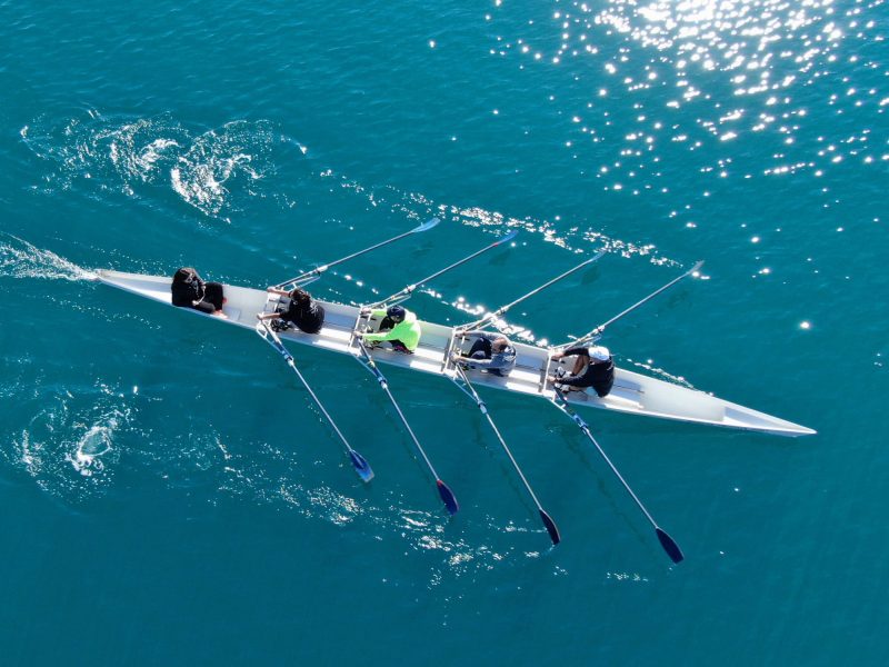 rowing team with four men and a cox in a boat
