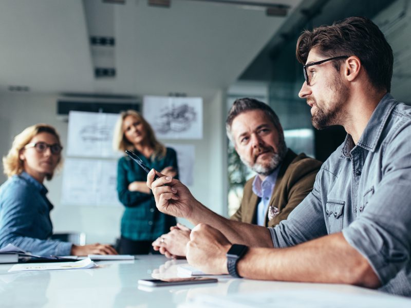 team of men and women around a table