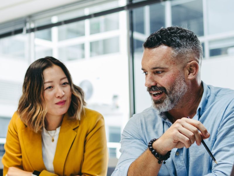 Man and woman seated at a table talking
