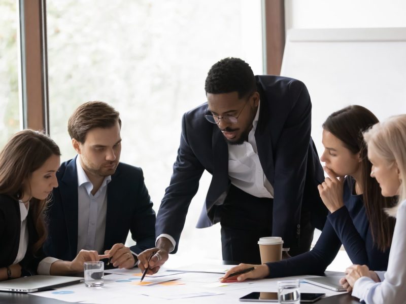 Team of men and women talking at a table