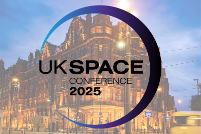 Logo of the UK Space Conference on top of an image of an old building Manchester